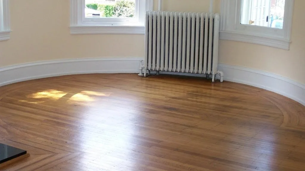 An empty room with a clear wooden floor